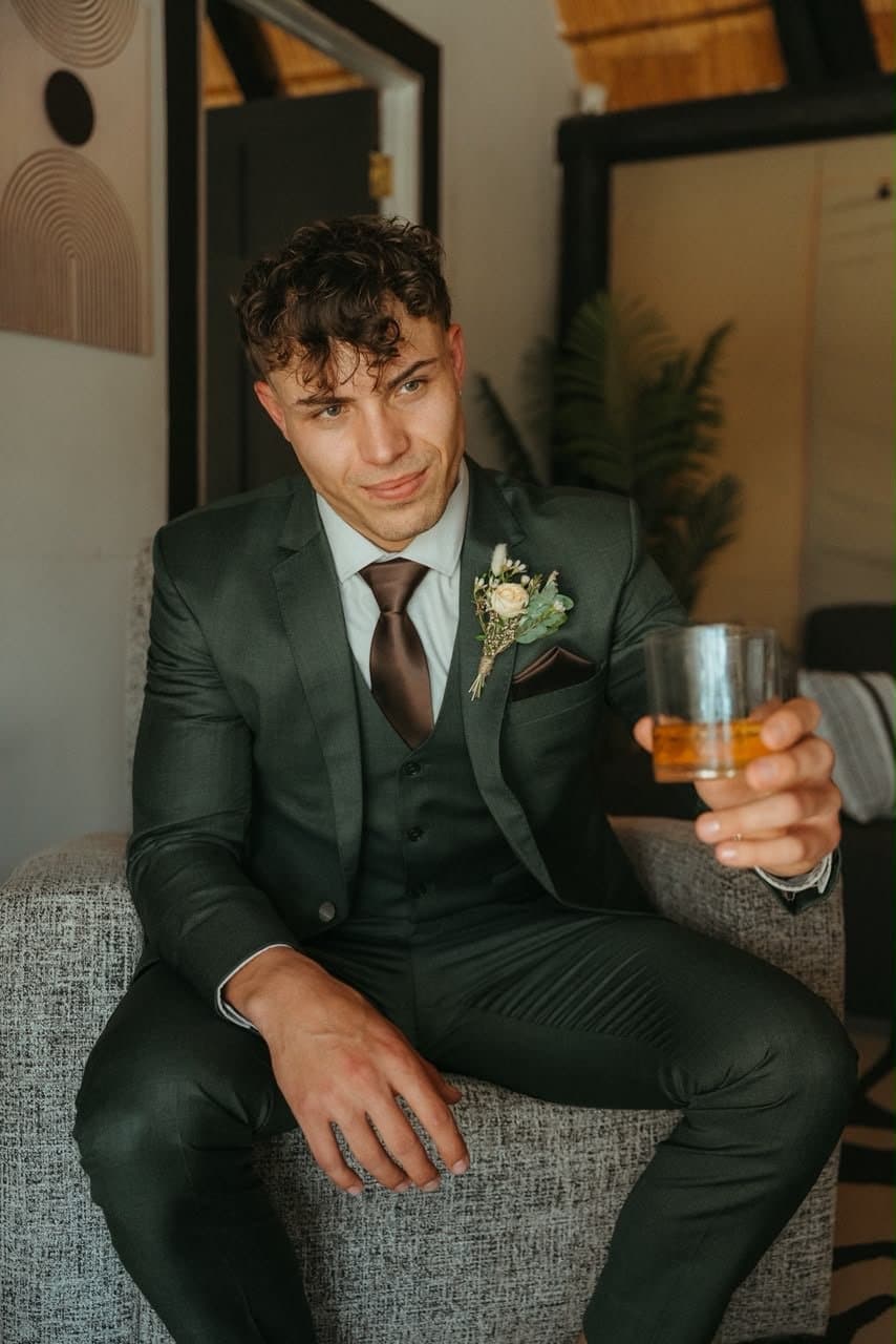 Juan in his green suit, whisky in hand, before the ceremony